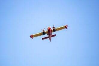 Canadair flight, Firefight Aircraft, scooper flying on blue sky, under view.
