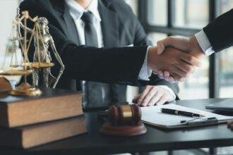 Lawyer and client shake hands.