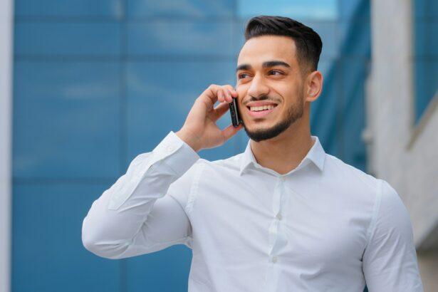 Hispanic indian bearded businessman with mobile phone at street smiling Arabian businessman manager