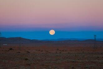 Big Moon under the Golden Sahara Desert Sands near the oasis town Taghit