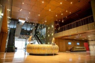modern hotel interior with round reception desk and sophisticated lobby design, escalators, moving