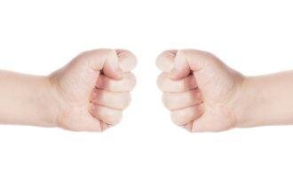 two opposing fists as symbol for conflict or fight