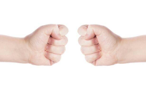 two opposing fists as symbol for conflict or fight