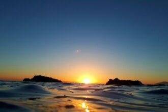 body of water during sunset